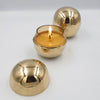 brass orb vessel with scented candle