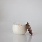 scented candle in glass jar with wooden cap