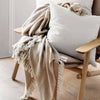 neutral wheat coloured cashmere throw rug styled on chair