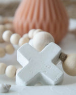 concrete cross and wooden beads closeup
