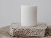 Ivory lined pillar candle on travertine slab
