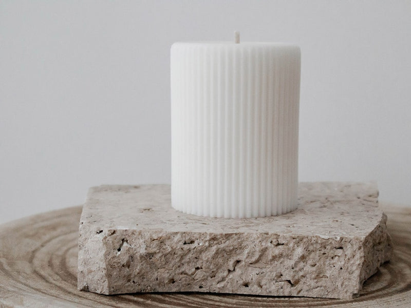 Ivory lined pillar candle on travertine slab