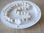 white round shallow concrete dish shell edging with beads