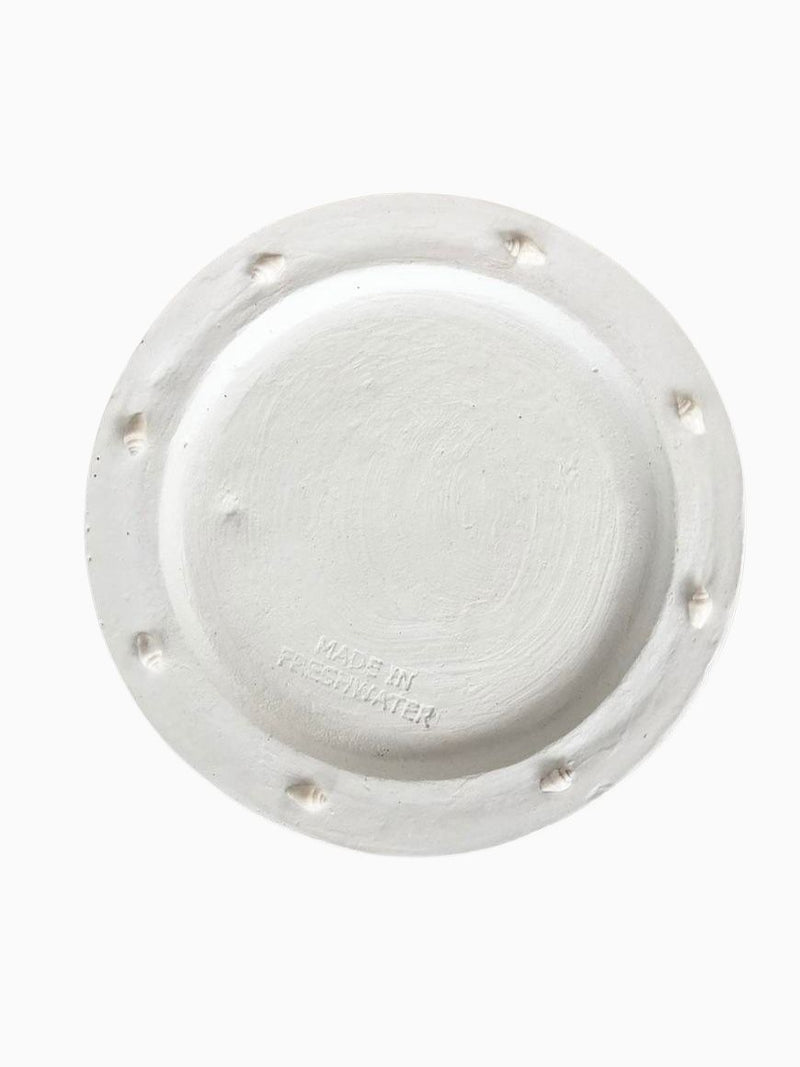 white round shallow dish shell edging top view