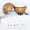teak orb scented candle styled on books