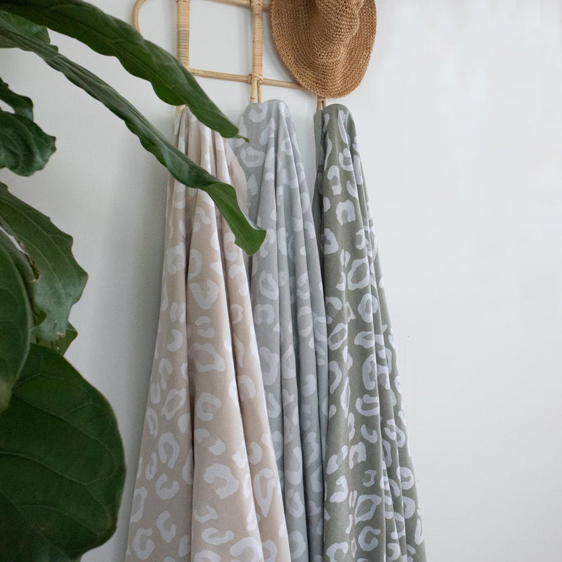 leopard print Turkish cotton towels styled on rattan wall hook