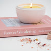 white ceramic orb candle styled with book